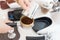 The process of making coffee step by step. Women tamping freshly ground coffee beans in a portafilter. A coffee roaster checking a