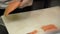 Process of making and cutting salmon for sushi rolls. Cook cutting up fish by knife on thin slices.