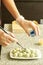 The process of making handmade chocolates. Chocolatier is covered with white chocolate candy. Selective focus.