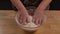 Process of making handmade dough from flour. Baker's woman's hands pours white flour into a glass bowl and mixes it