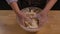 Process of making handmade dough from flour. Baker's woman's hands pours white flour into a glass bowl and mixes it