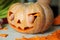 Process of making Jack-o-lantern. Funny picture of Halloween pumpkin monster face with male fingers.