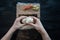 Process of making maki sushi. Cook chef hands preparing rolls with cheese, avocado and sesame seeds on wooden board