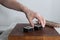 Process of making maki sushi. Cook chef hands preparing rolls with cheese, avocado and sesame seeds on wooden board