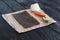 Process of making maki sushi. Cook chef hands preparing rolls with cheese, avocado and sesame seeds on wooden board