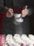 Process of making marshmallow. Close up hands of the chef with metal sieve sprinkling zephyr with Powdered sugar at pastry shop