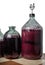 The process of making red homemade wine. Bottles with a must with an airlock in a cork.