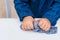 Process of making slime. Blue magic glitter slime on a white background. Child crumples slime. Close up of hands.