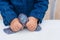 Process of making slime. Blue magic glitter slime on a white background. Child crumples slime. Close up of hands.