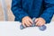 Process of making slime. Blue magic glitter slime on a white background. Child crumples slime. Close up of hands.