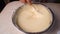 Process of making and whisking the dough, woman`s hand mixing liquid dough with whisk in bowl.