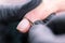 Process manicure close-up. Preparation for hardware manicure. Beautician in rubber gloves cuts the cuticle and processes