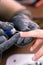 Process manicure close-up. Preparation for hardware manicure. Beautician in rubber gloves cuts the cuticle and processes