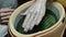 Process paraffin treatment of female hands in beauty salon.