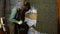 The process of plastering the wall, a man with a trowel in his hands plasters the wall with a concrete liquid mortar.