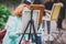 Process of plein air painting, group class of adult talented students in the park with paints easels, and canvases during lesson