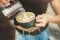 Process of pouring whipped cream to hot coffee drink , barista work close up