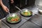 The process of preparation of grilled vegetables. Vegetables on the grill pan. Chef`s hands.