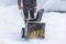 Process of removing snow with portable blower machine, worker dressed in overall workwear with gas snow blower removal on the