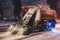 Process of snow removal on the city streets and roads with municipal vehicle, bulldozer, snowblower plow truck, snowplow, snow