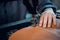 The process of stitching two pieces of genuine leather by a shoemaker on a special old-school sewing machine. Stitches