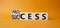 Process and Success symbol. Turned cube with words success and process. Beautiful orange background. Businessman hand. Business