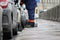 Process of urban street cleaning sweeping. Worker with broom and dust pan