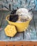 The process of washing dishes. Crockery in a yellow enameled cup with plenty of foam from detergent and a sponge