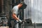 Process of welding. Young factory worker in grey uniform