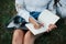 Process of writing. Young woman have weekend and sits in the park at daytime