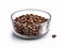 Processed coffee beans are placed in a transparent glass container and isolated on white background.