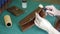 Processing and manufacturing of leather goods with a power tool close-up on a blurred background of a workshop