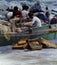 PROCIDA, ITALY, 1979 - Some fishermen repair their nets with skill and patience and dry some fish boxes in the Procida sun