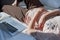 Procrastination, rest from work: a woman rests in bed next to a computer.