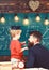 Prodigy child concept. Teacher with beard, father teaches little son in classroom, chalkboard on background. Boy, child