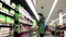 Produce clerk stocking lettuce salad