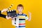 Producer making film. Boy holding paper paper sheet with exclamation mark. Thoughtful child over yellow background. New idea for