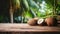 Product display rustic old wooden boards table with coconut farm in background.