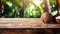 Product display rustic old wooden boards table with coconut farm in background.