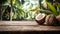 Product display rustic old wooden boards table with coconut farm in background.