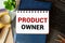 PRODUCT OWNER . Text written on the notepad with office tools and documents