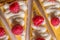 Product photography of lemon cheesecake with raspberries on white background, zig zag pattern of cake slices