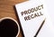 PRODUCT RECALL - text on notepad on wooden desk