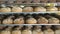 Production of bakery products. Freshly baked ruddy bread lies on the shelves in the bakery. Lots of bread on the shelves