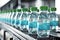 Production line of bottled beverages in plastic bottles on clean factory floor. created with Generative AI