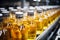 Production line fills glass bottles with vibrant apple and pineapple juice beverages