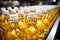 Production line fills glass bottles with vibrant apple and pineapple juice beverages