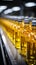 Production line fills glass bottles with vibrant apple and pineapple juice beverages