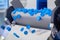 Production line - many blue plastic bottle caps falling from conveyor belt