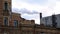 A production pipe smokes over city roofs of houses